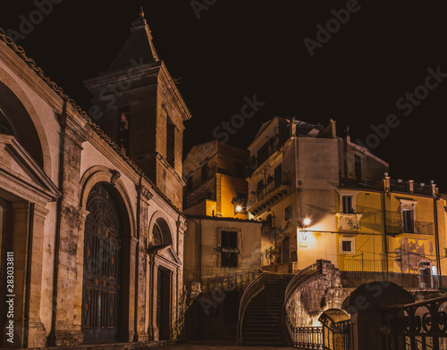 Night view over the Santa Maria dell'Itria church and empty street in the famous baroque town Ragusa Hybla in Sicily, south Italy photo