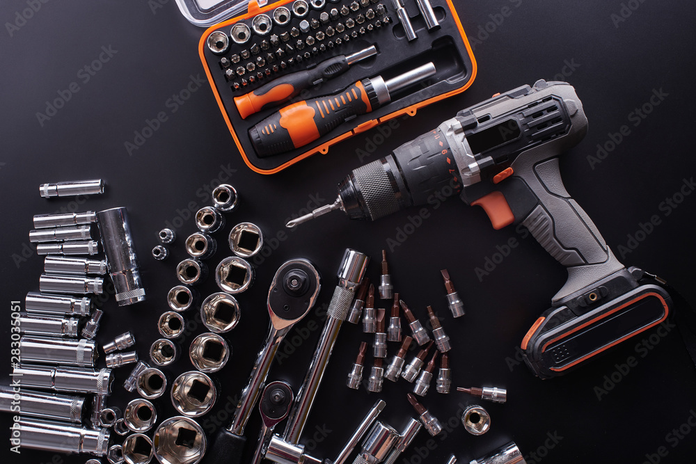 Naklejka premium Industrial locksmith tools and screwdriver on a black background