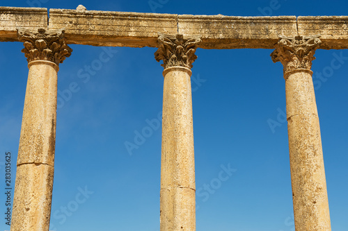 Corinthian Columns over the blue sky at the ruins of the Colonnade street in the ancient Roman city of Gerasa (modern Jerash) in Jordan.