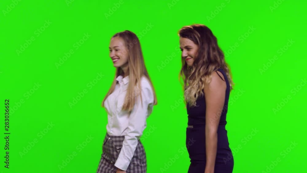 Window shopping of two fashionable female friends over green screen. Getting to a window, looking, and entering. 3 takes. Window shopping of two fashionable female friends over green screen. Getting to a window, looking, and entering. 3 takes.