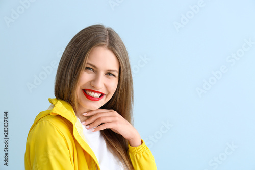 Portrait of young woman on color background