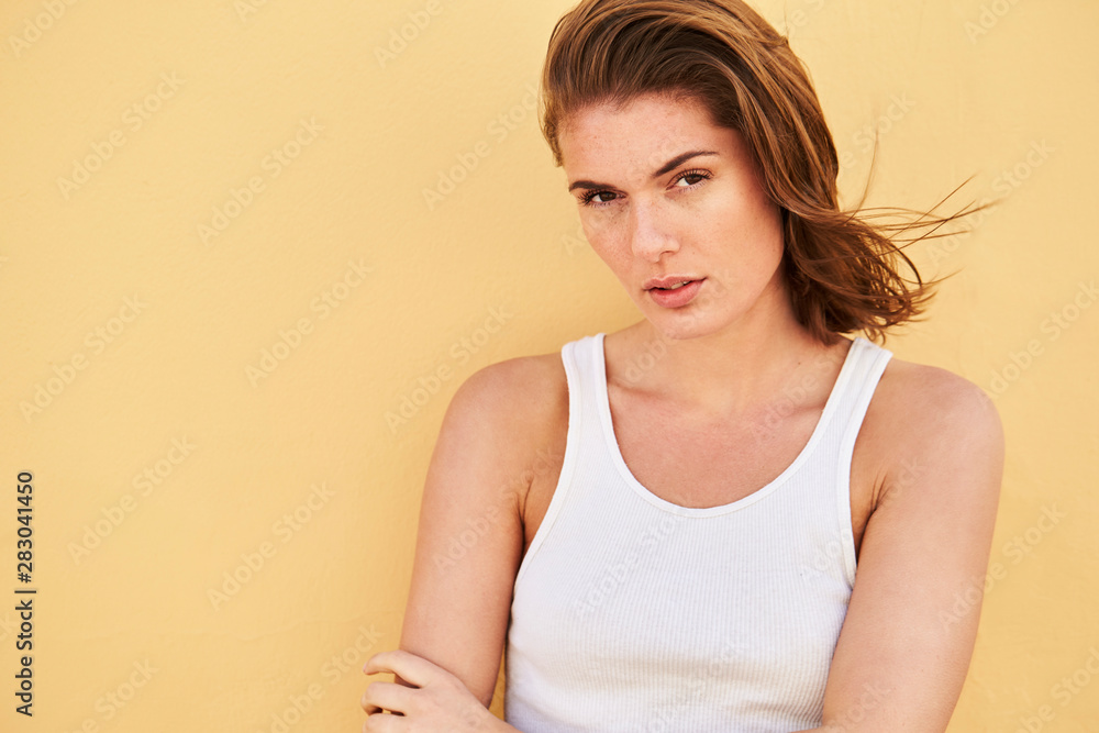 Beautiful young model in white against yellow background Beautiful young model in white against yellow background