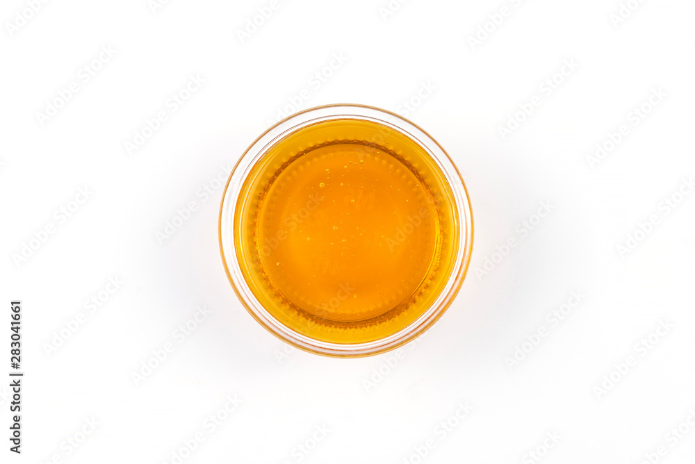 Honey in a jar on a white background Honey in a jar on a white background
