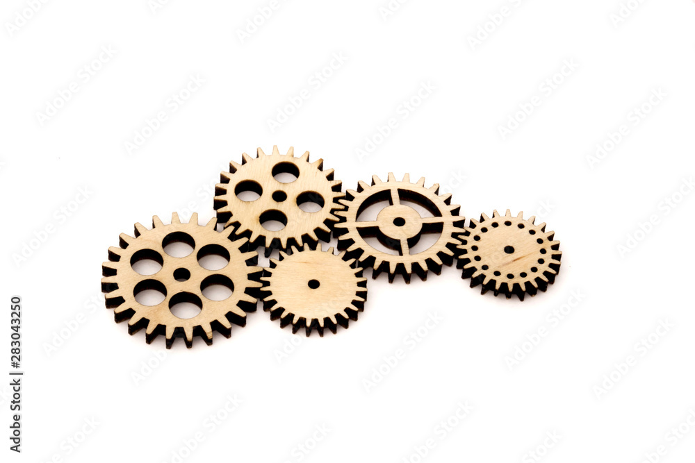 connected wooden gears of different size isolated on white background. connected wooden gears of different size isolated on white background.