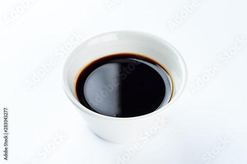 Thick dark soy sauce on a light background
