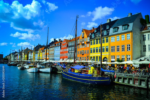 Scenic summer view of Nyhavn pier with color buildings, ships, yachts and other boats in the Old Town of Copenhagen, Denmark- August 3, 2019