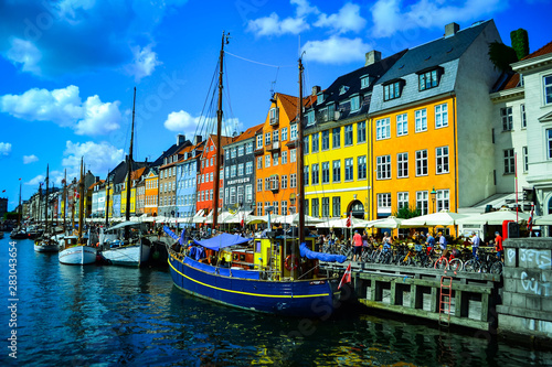 Scenic summer view of Nyhavn pier with color buildings, ships, yachts and other boats in the Old Town of Copenhagen, Denmark- August 3, 2019