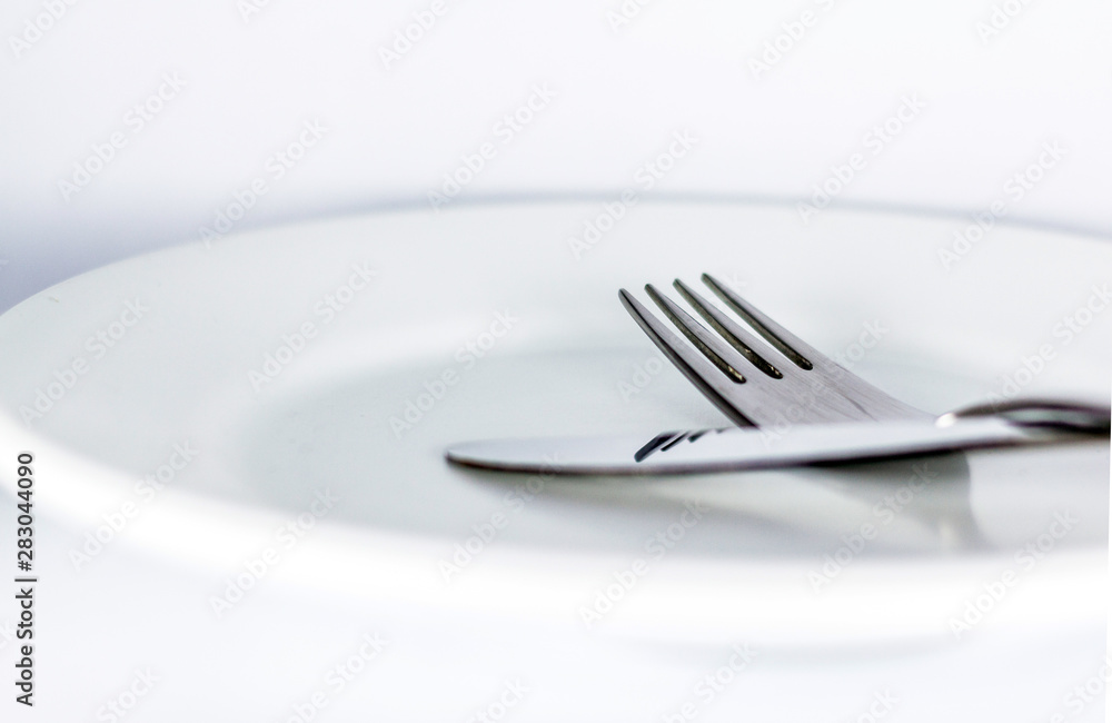 White empty plate with fork and knife White empty plate with fork and knife