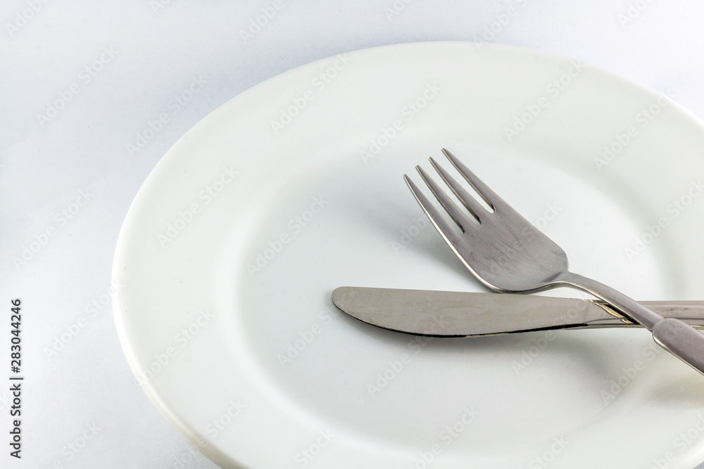 White empty plate with fork and knife White empty plate with fork and knife