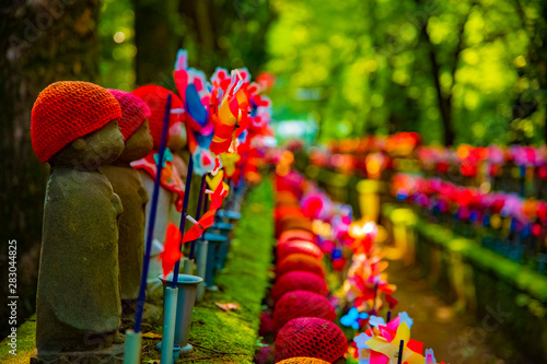 Statue guardian wearing red hat in Tokyo daytime photo