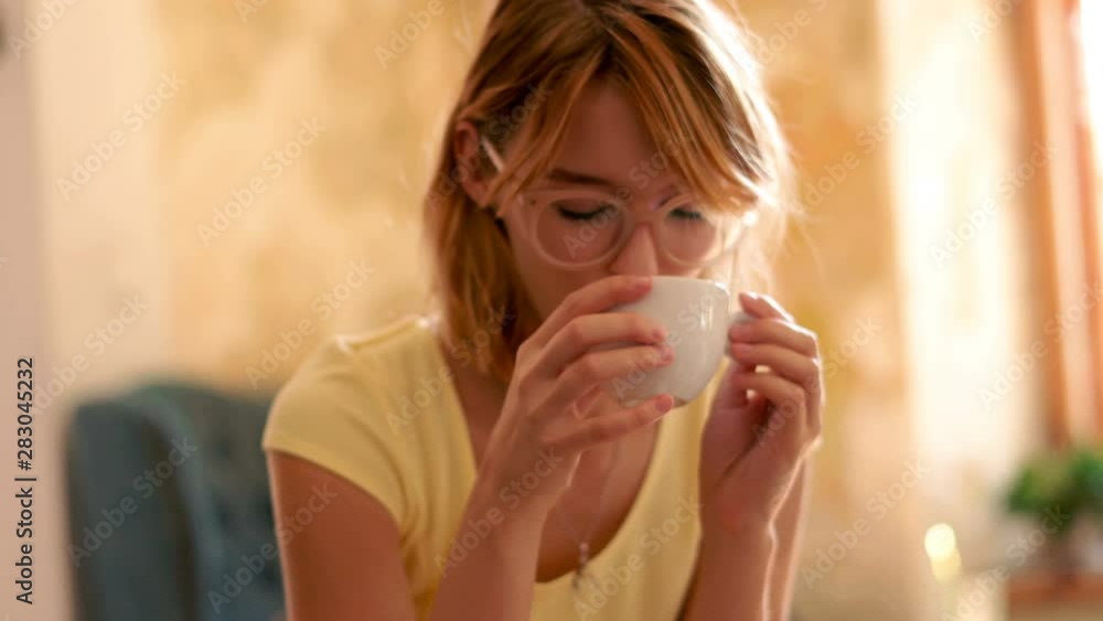 Young beautiful woman drinking coffee in cafe, 4k Young beautiful woman drinking coffee in cafe, 4k