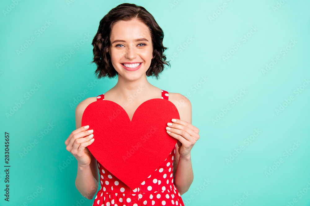 Photo of gorgeous attractive nice cute girl who asked to photograph her with newly gifted heart while isolated with teal background Photo of gorgeous attractive nice cute girl who asked to photograph her with newly gifted heart while isolated with teal background