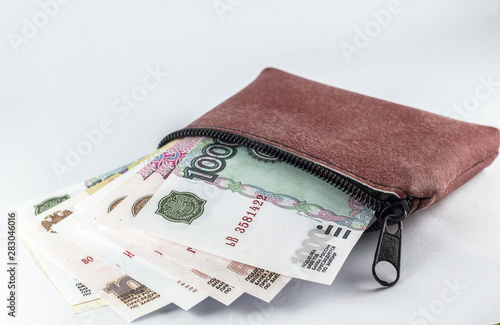 Russian ruble in a leather bag on a white background.