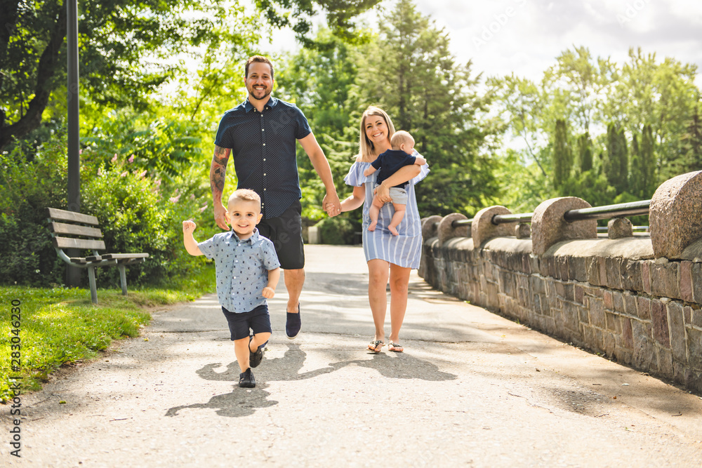 Fototapeta premium Happy family having fun resting in park