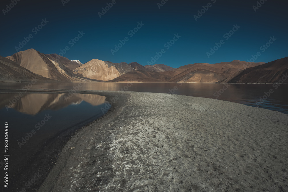 Fototapeta premium Lake in valley with mountains and blue sky background, Himalaya mountains in India