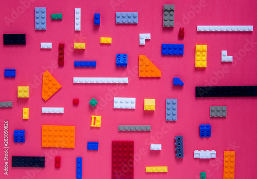 Background for children's site, for the menu. Children's constructors on pink. Multi-colored cubes. Games for motor developing memory and mind.