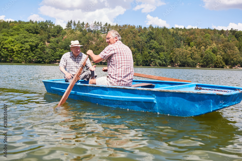 Senior man and his father rowing Senior man and his father rowing