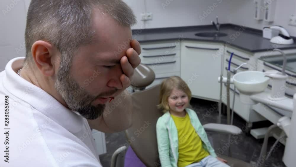Dentist plays with a child who came for an examination Dentist plays with a child who came for an examination