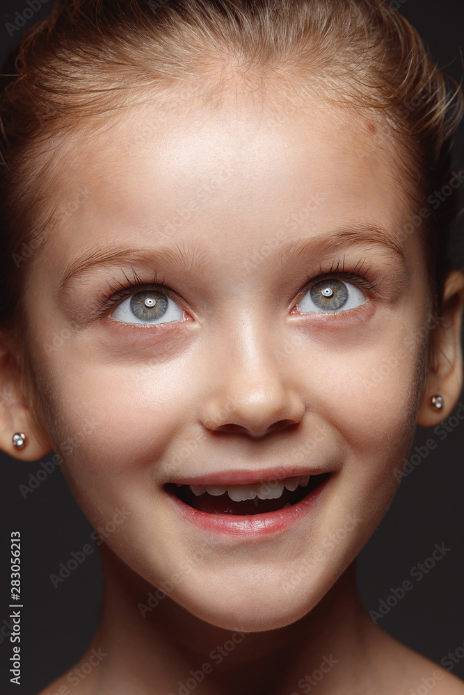 Close up portrait of little and emotional caucasian girl. Highly detail photoshot of female model with well-kept skin and bright facial expression. Concept of human emotions. Dreaming, looking up. Close up portrait of little and emotional caucasian girl. Highly detail photoshot of female model with well-kept skin and bright facial expression. Concept of human emotions. Dreaming, looking up.