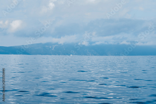 Picturesque Adriatic sea landscape with rocky shores, Horatia, blue colors background