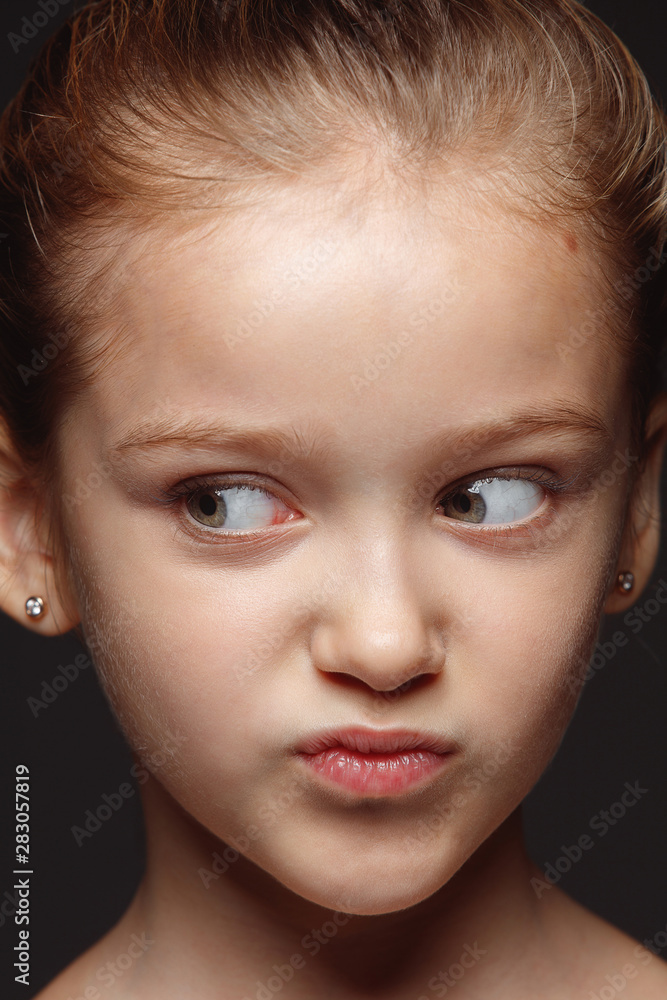 Close up portrait of little and emotional caucasian girl. Highly detail photoshot of female model with well-kept skin and bright facial expression. Concept of human emotions. Playful, looking at side. Close up portrait of little and emotional caucasian girl. Highly detail photoshot of female model with well-kept skin and bright facial expression. Concept of human emotions. Playful, looking at side.
