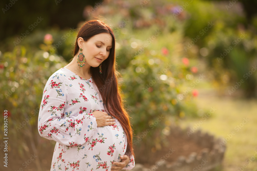 happy pregnant woman looking at her belly happy pregnant woman looking at her belly
