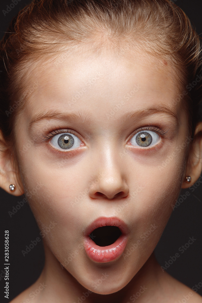 Close up portrait of little and emotional caucasian girl. Highly detail photoshot of model with well-kept skin and bright facial expression. Concept of human emotions. Astonished, looking at camera. Close up portrait of little and emotional caucasian girl. Highly detail photoshot of model with well-kept skin and bright facial expression. Concept of human emotions. Astonished, looking at camera.