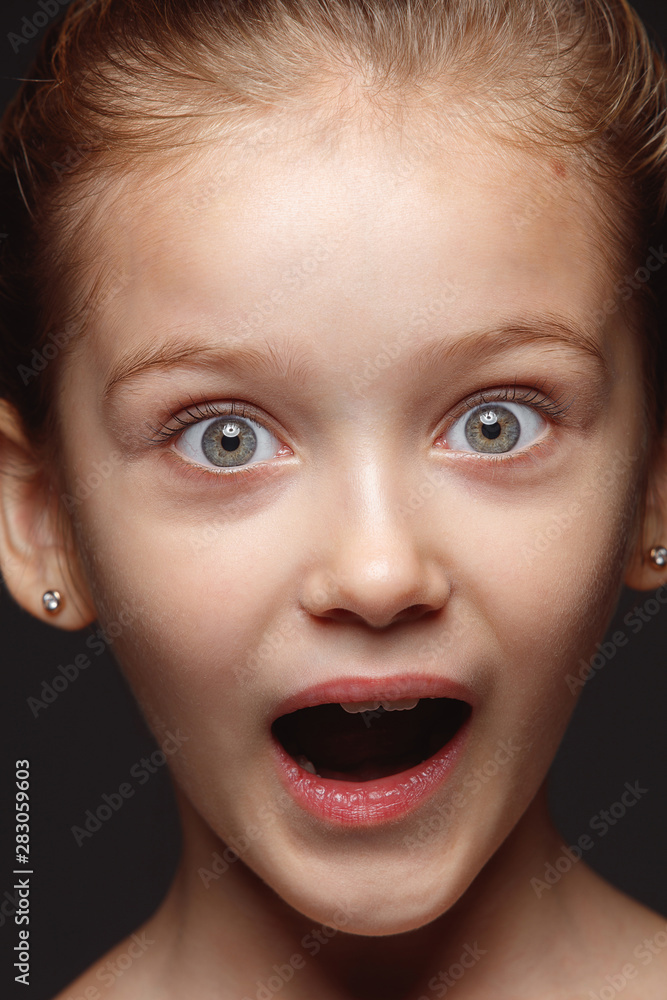 Close up portrait of little and emotional caucasian girl. Highly detail photoshot of model with well-kept skin and bright facial expression. Concept of human emotions. Astonished, looking at camera. Close up portrait of little and emotional caucasian girl. Highly detail photoshot of model with well-kept skin and bright facial expression. Concept of human emotions. Astonished, looking at camera.