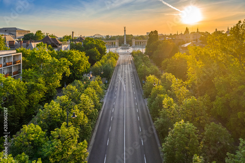 Budapest, Hungary - Aerial drone view of Andrassy street at sunrise with Heroes' Square (Hosok tere) at background at summer time