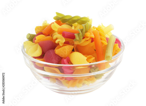 Colorful macaroni or pasta in glass bowl isolated on white background