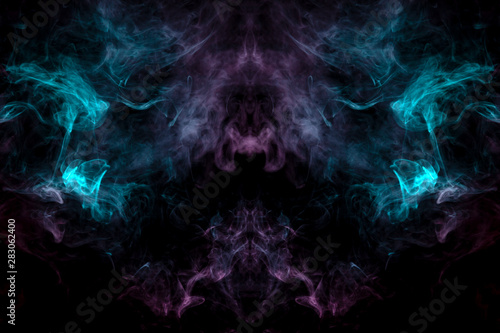 A mystical image of a large face of a creature or ghost with eyes and cheekbones of green and pink smoke on a black isolated background. Print for clothes.