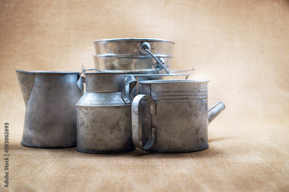 Metal zinc bucket and bottle with sack background Metal zinc bucket and bottle with sack background