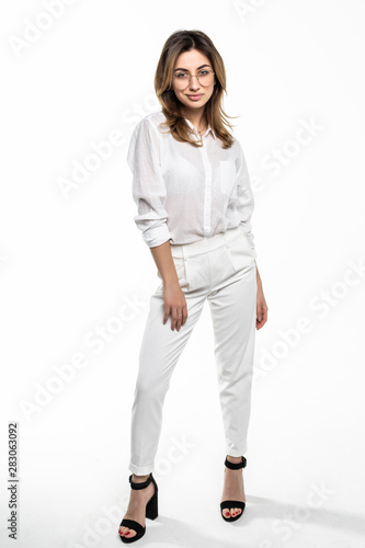 Full length portrait of a smiling pretty woman isolated over white background