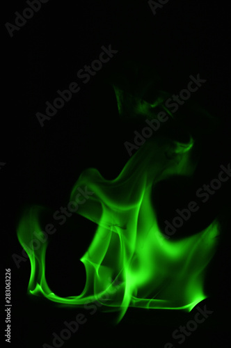 Beautiful fire green flames on a black background. © Suchart