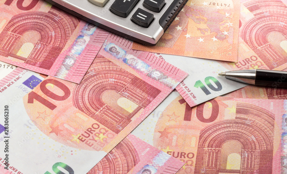 euro banknotes with pen, coin and calculator. euro banknotes with pen, coin and calculator.