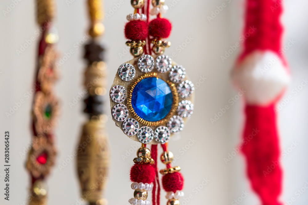 Different Styles Of Rakhi Hanging In A Shop