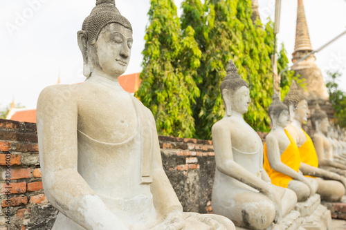 Row of Buddha statues in Wat Yai Chaimongkol in Ayutthaya  Thailand.