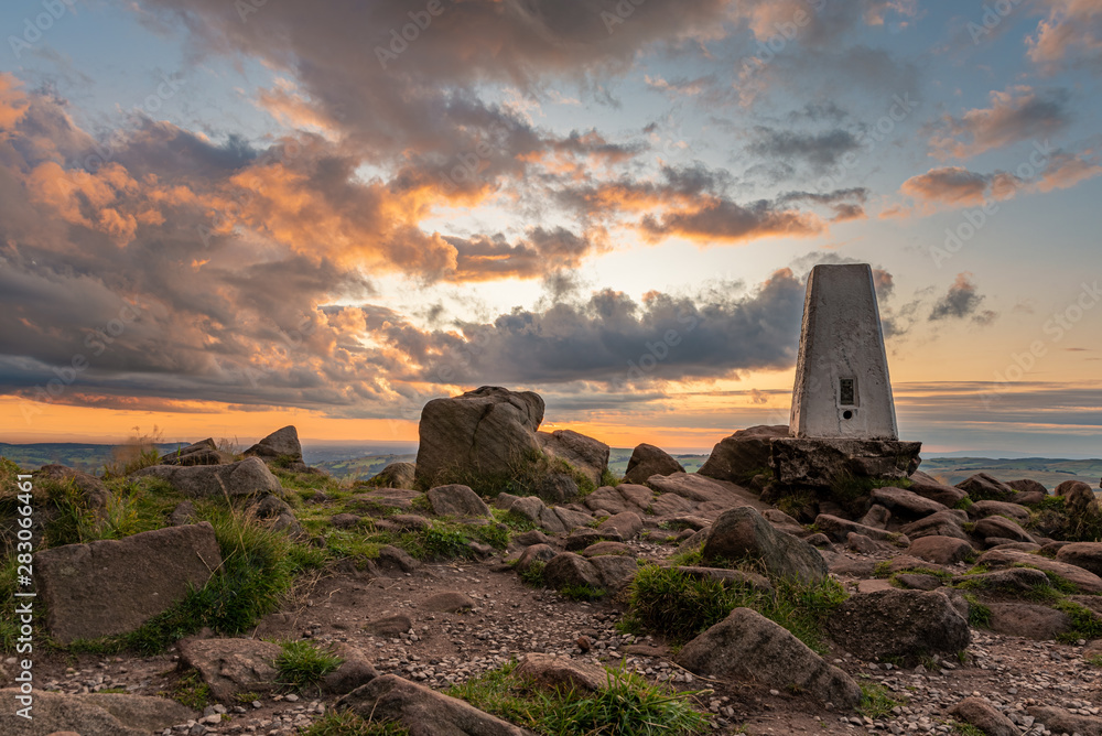 Trig point on top of The Roaches at sunset in the Peak District National Park.