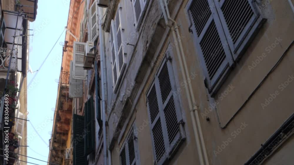 From Down to Up Shot Apartment Builidings in Alley . Old quarter with beautiful facede in European Street with palace in characteristic neighborhood with small balcony. From Down to Up Shot Apartment Builidings in Alley . Old quarter with beautiful facede in European Street with palace in characteristic neighborhood with small balcony.