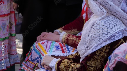 Close up Details of Mediterranean Women sitting during Typical celebration in Corfu festival. Traditional Costumes of Hellenic culture. photo