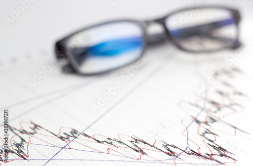glasses and graphic chart