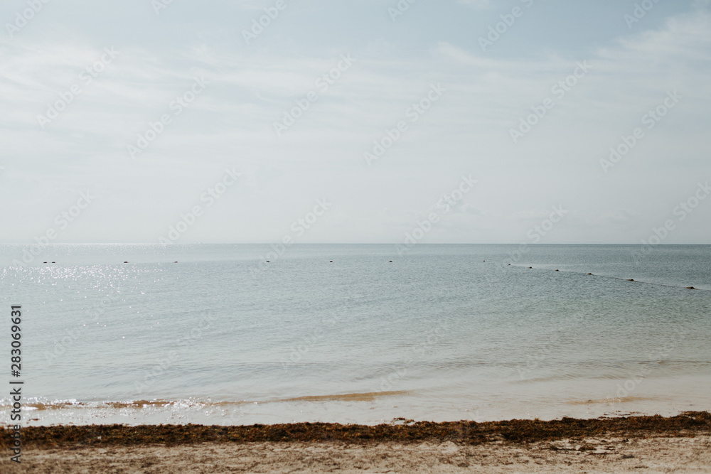 beach in mexico, cloudy sky and blue water