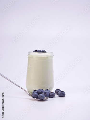 Fresh blueberry yogurt glass on a white background