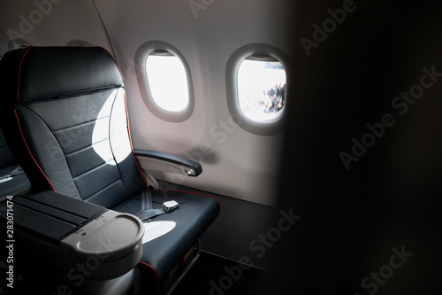 Airplane cabin seats with passengers. Economy class of new cheapest low-cost airlines without delay or cancellation of flight.