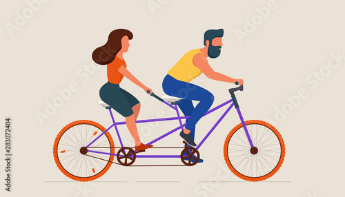 Man and woman riding tandem bicycle