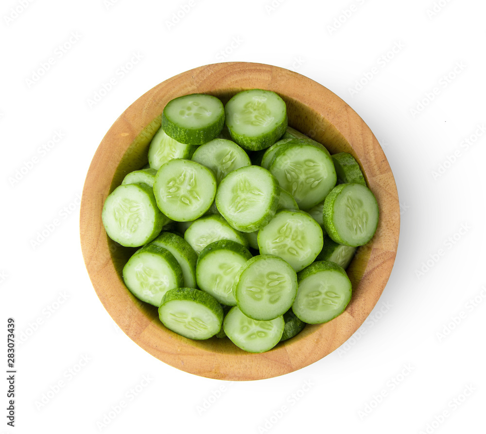 Fresh cucumber slices in wood bowl isolated on white background. top view Fresh cucumber slices in wood bowl isolated on white background. top view