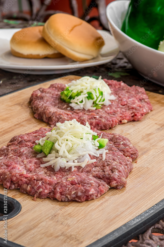 Fresh Beef Patties on a Bamboo Coating Board Fresh Beef Patties on a Bamboo Coating Board