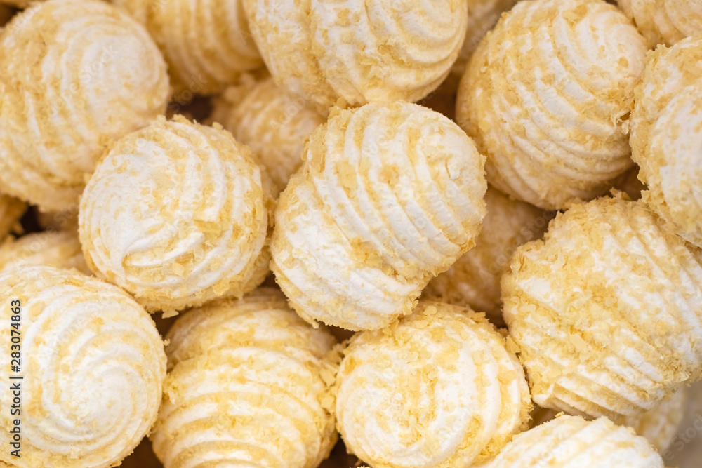 A pile of vanilla white delicious marshmallows in a waffle crumb closeup, background