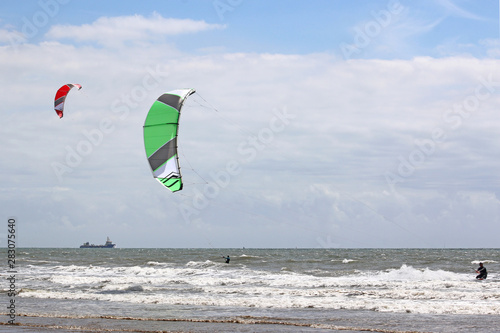 kitesurfers riding the waves