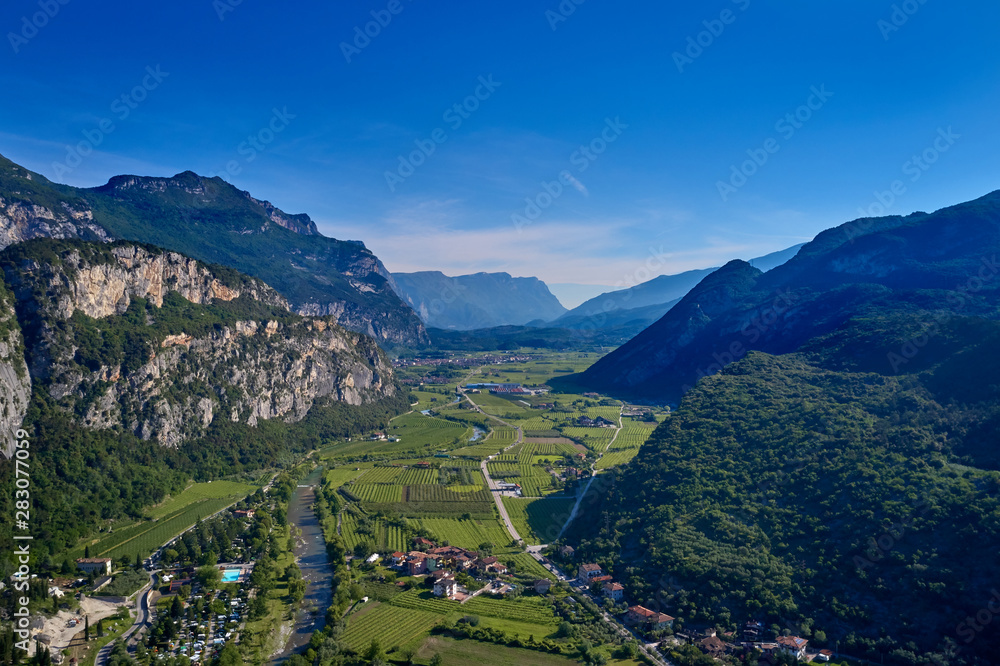 Aerial view of Lake Garda, mountains, cliffs and the city of Riva del Garda, Italy.